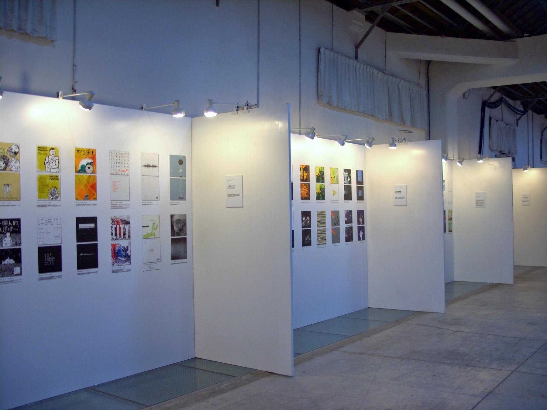 a white wall with pictures of people on it - File:2012GMX Day1 Graphic Design Exhibition.jpg