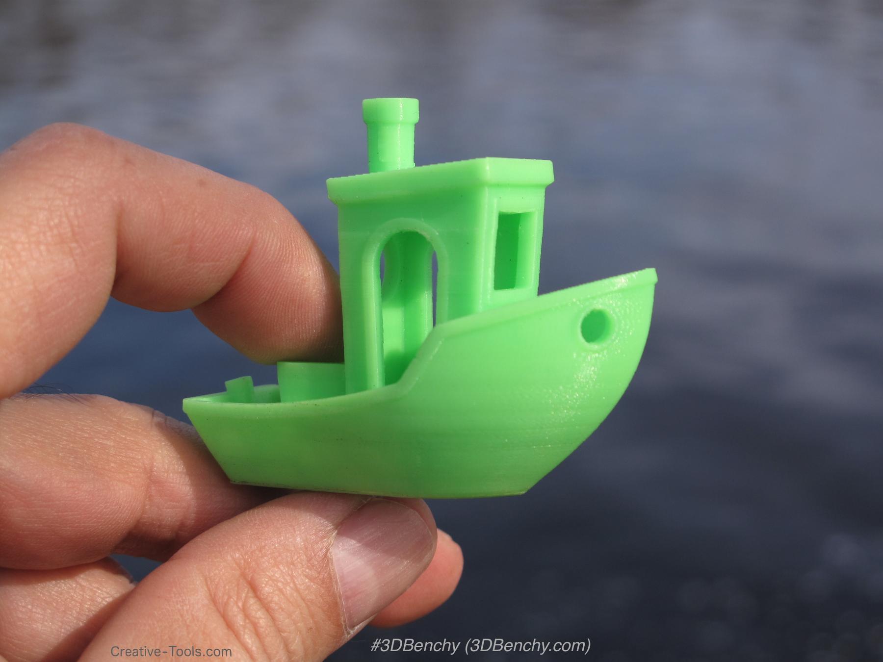 3D-printed 3DBenchy by Creative Tools - a green boat toy